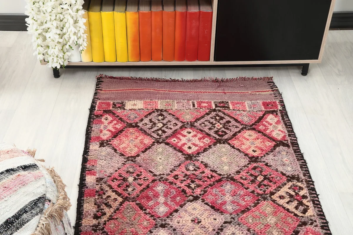 Top-down angle view of the rug in a room, focusing on its geometric design
