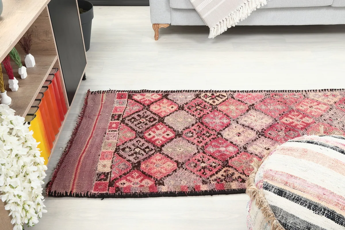 Long view of the runner rug stretching across a room, showcasing its length and pattern