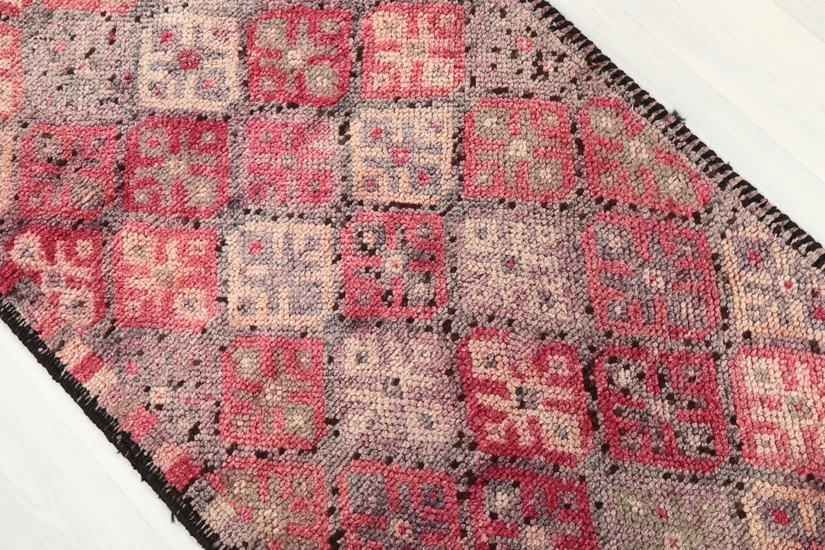 Overhead detail of the rug's surface, highlighting the individual geometric motifs