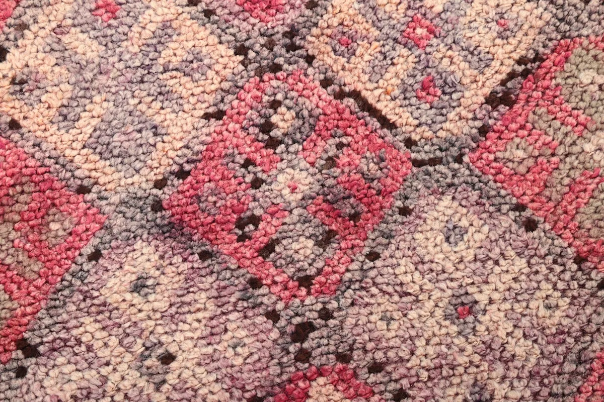 Close-up of the low wool pile and the intricate hand-knotted details of the rug
