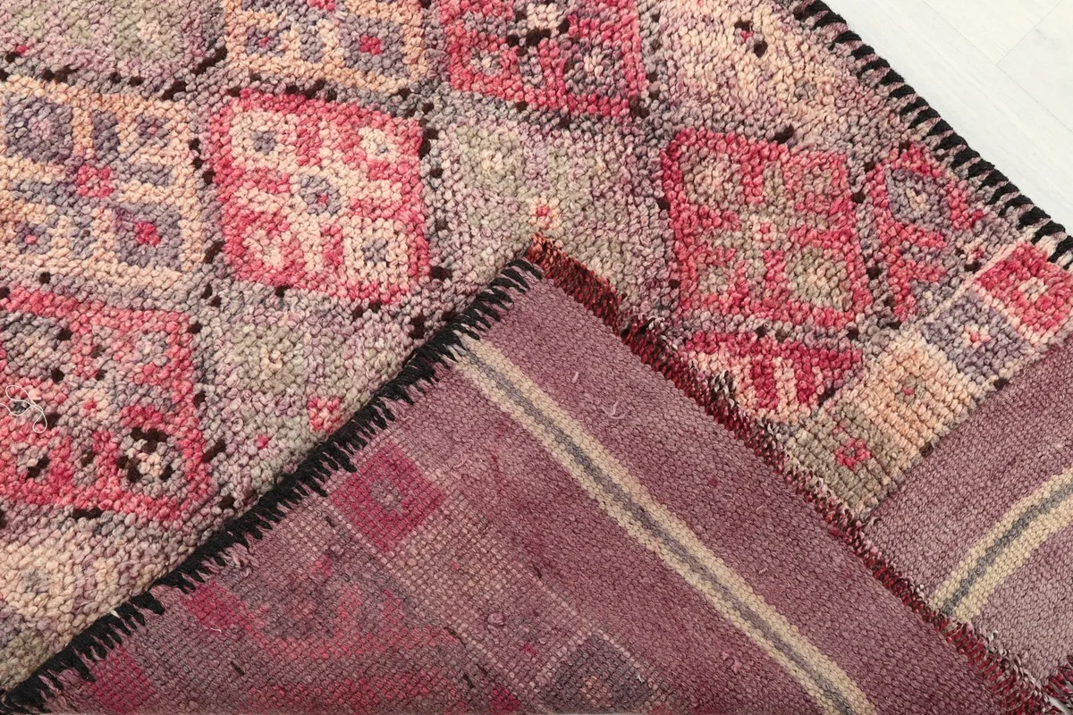 View of the rug's reverse side, revealing the hand-knotted construction and foundation