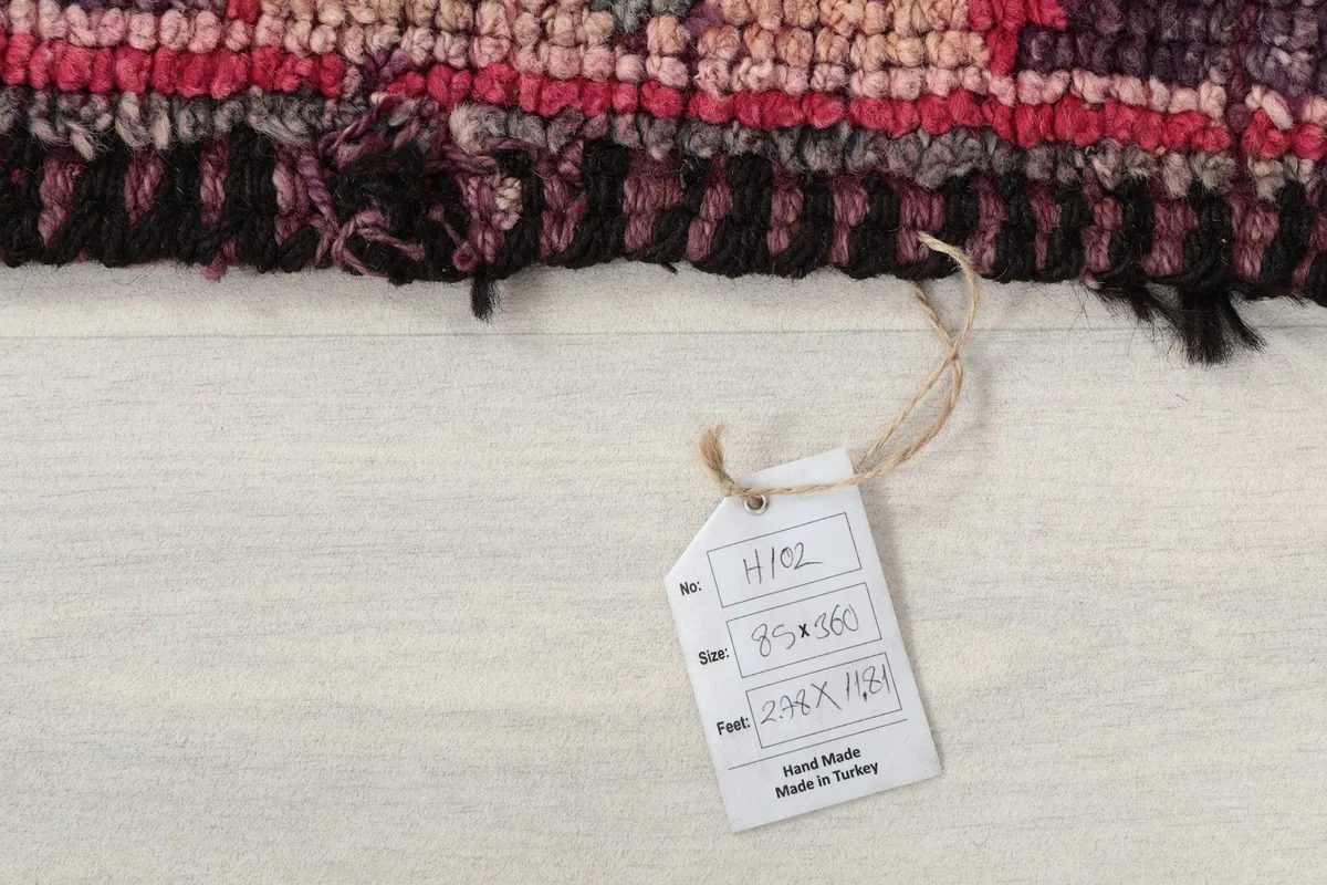 Product tag showing the rug's dimensions in centimeters and feet, confirming it is hand-made in Turkey.