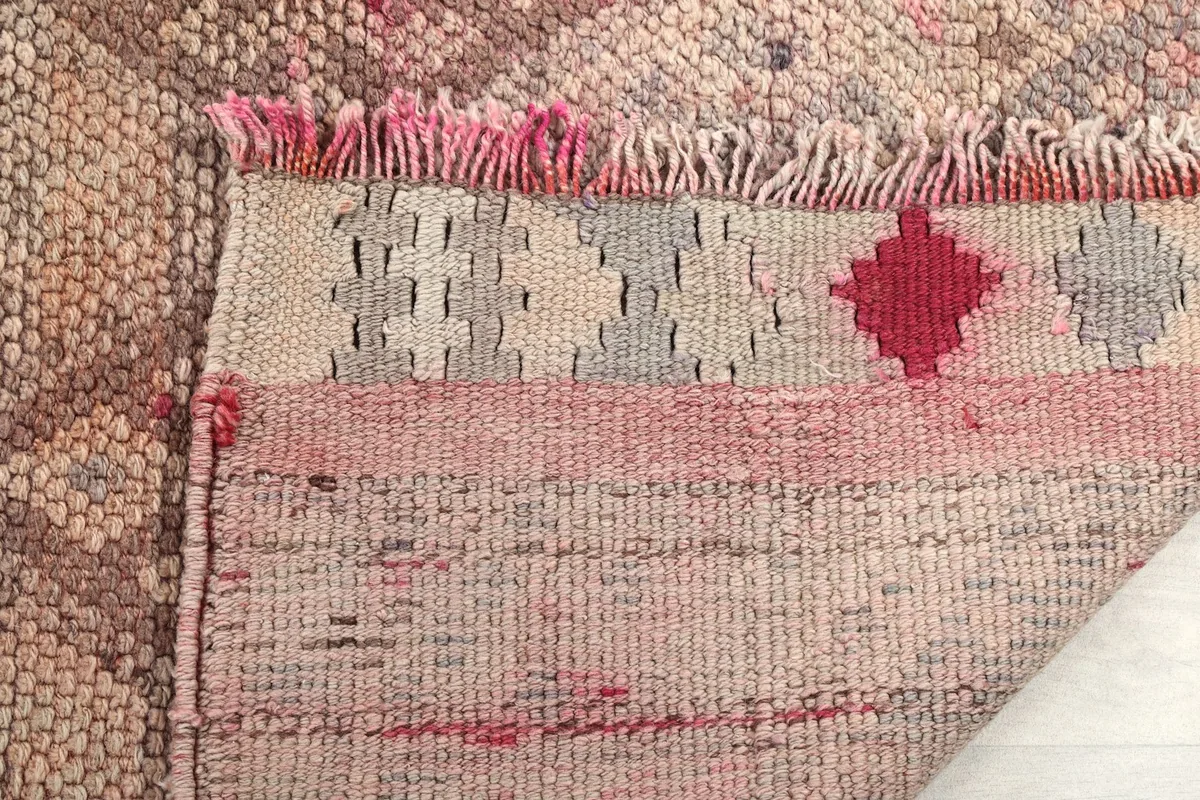 Close-up of the back of the rug, revealing the intricate knotting and the cotton foundation.