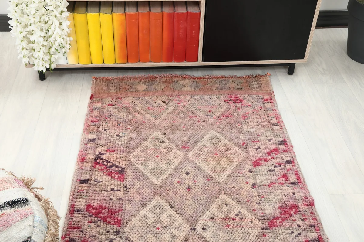 Overhead view focusing on the central geometric design of the rose runner in a room.