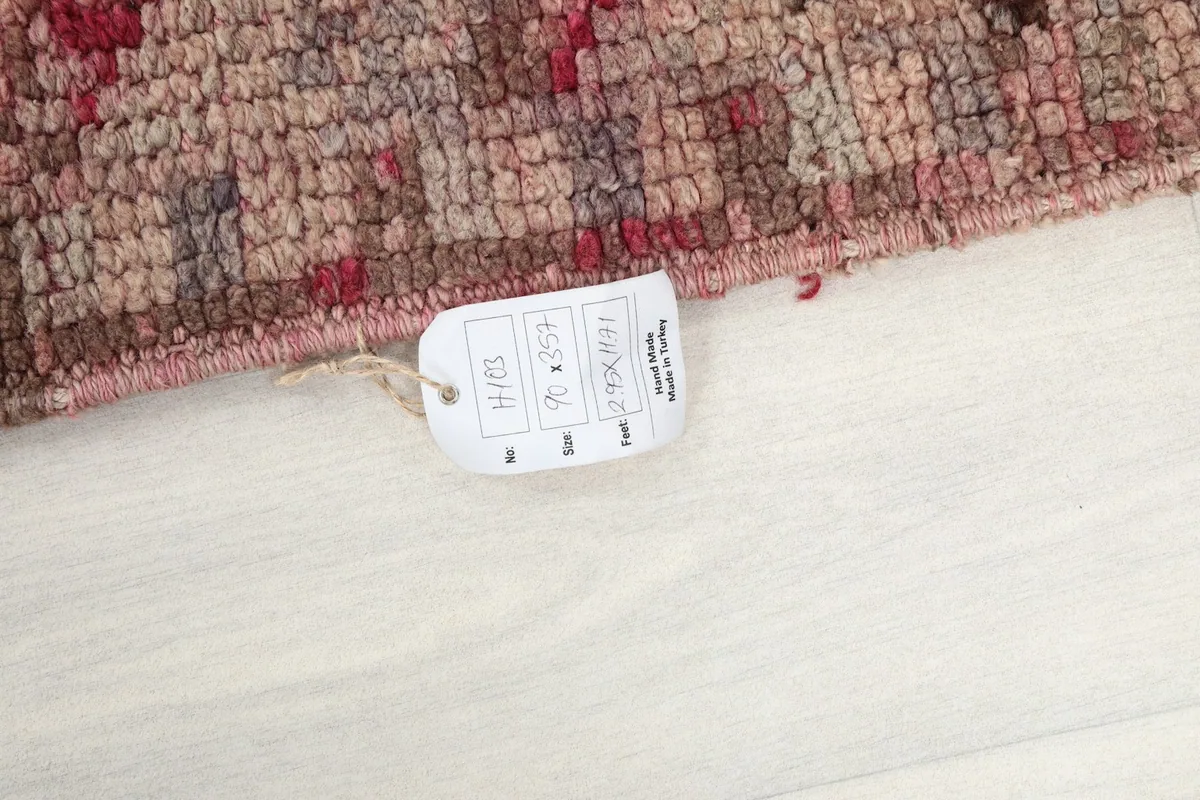 Product tag attached to the rug's edge, displaying size and origin information.