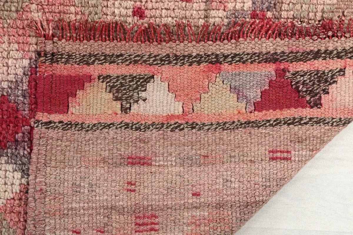Close-up of the rug's reverse side, showing the intricate knotting and foundation structure