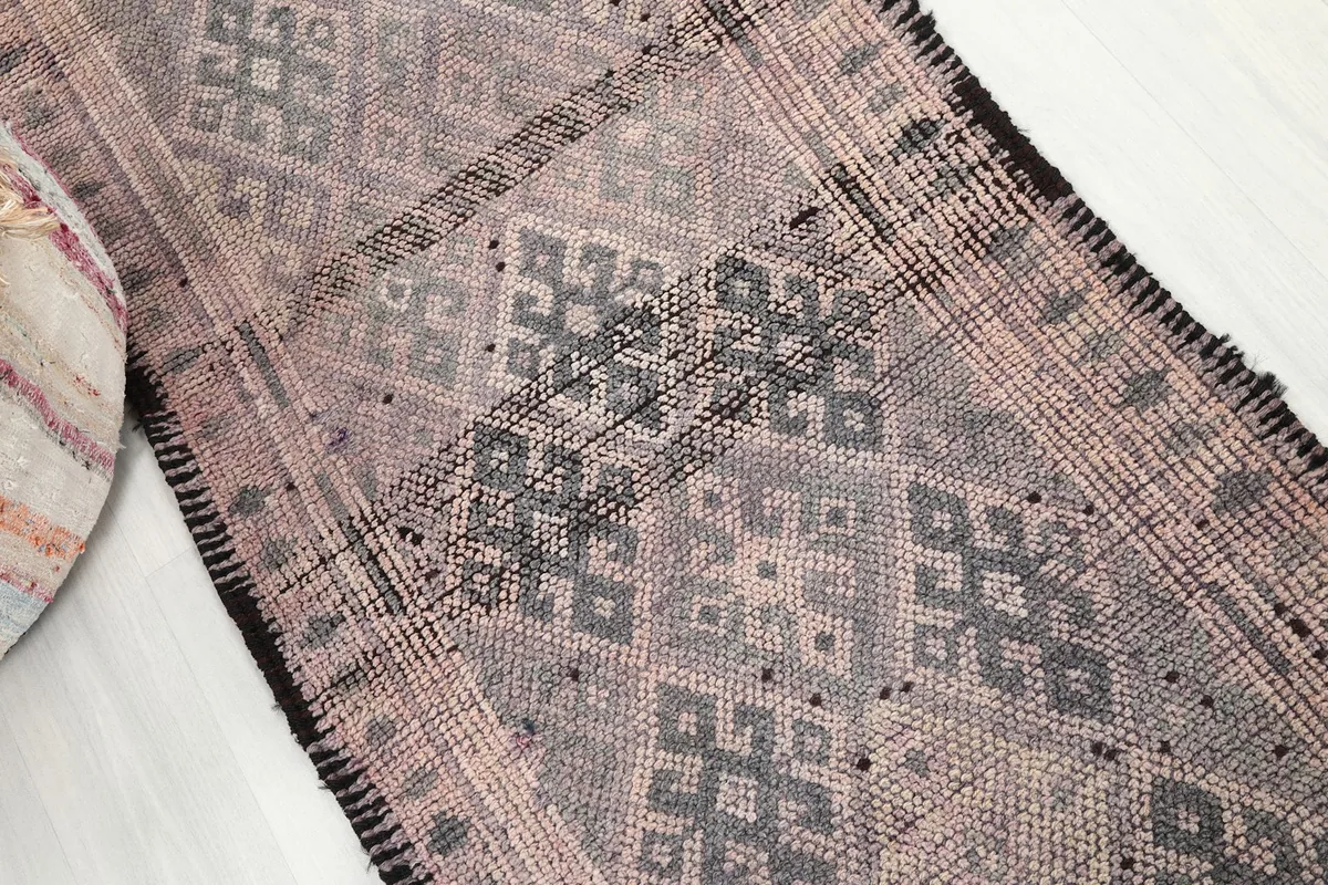 Overhead angle shot showcasing the central geometric motifs and the rug's overall pattern.