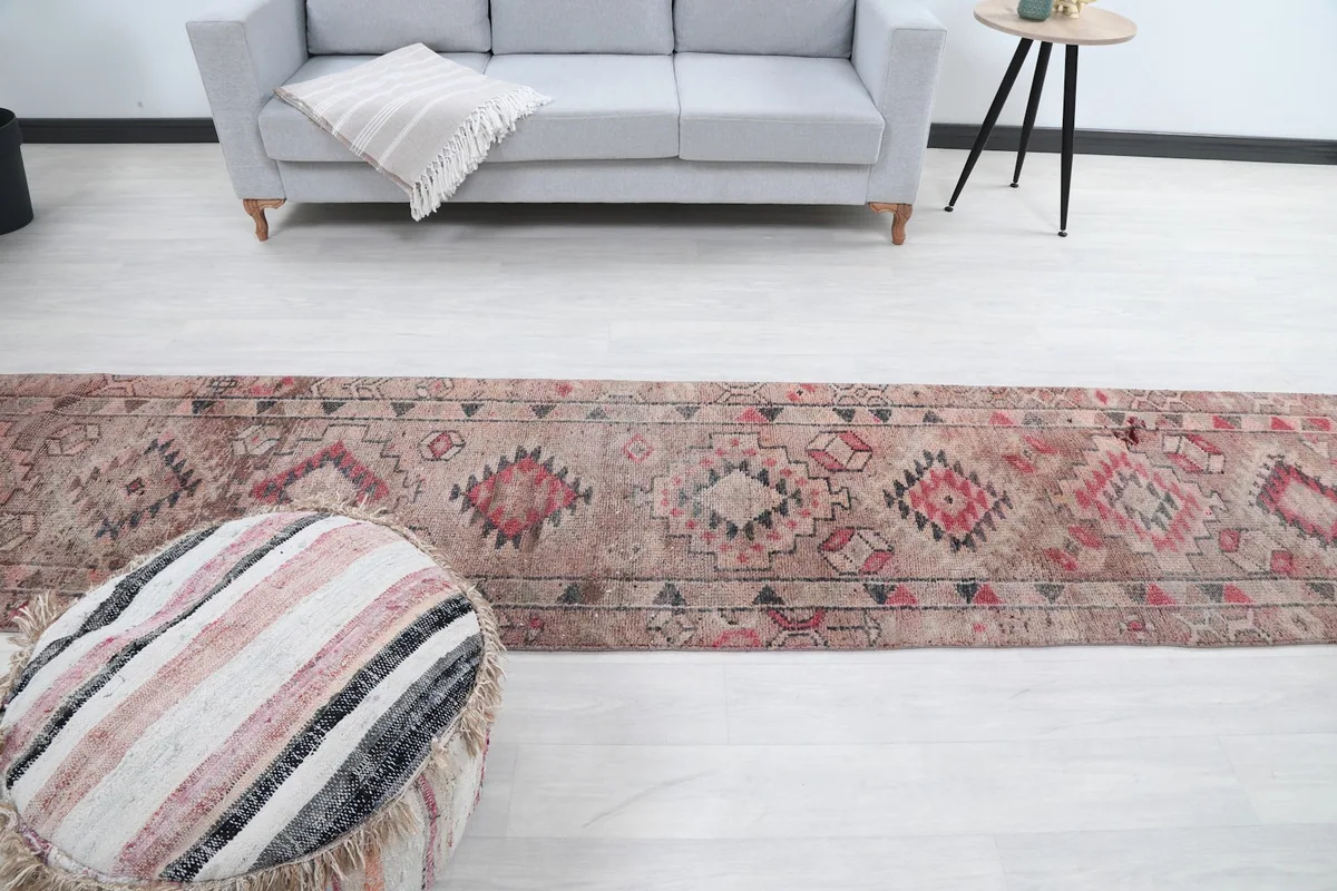 From above, the runner rug in a room with a sofa and ottoman, offering a full perspective of its design