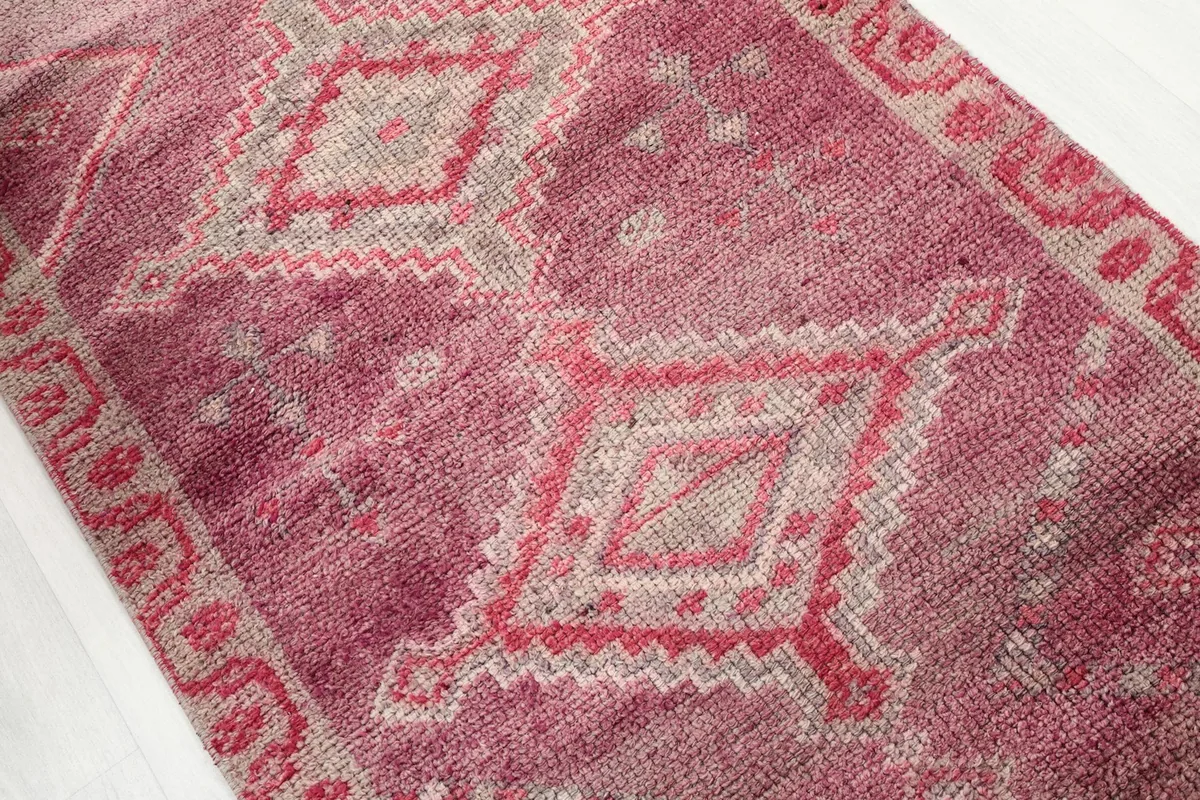 Angled view highlighting the repeating geometric diamond patterns along the runner