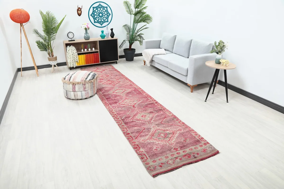Angle view of the rose geometric runner in a room, showing its length and design