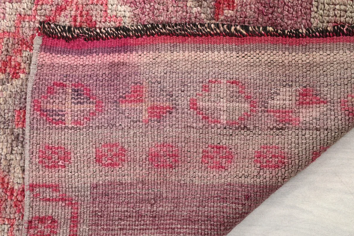 Close-up detail of the low wool pile and the tightly woven cotton foundation
