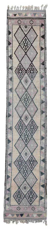Full top view of the beige, rose, and gray geometric tribal runner rug on a white background