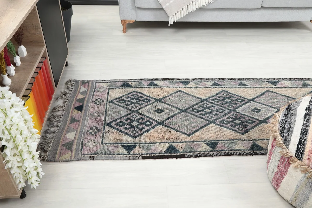 Runner rug extending through a room, showing its placement relative to furniture