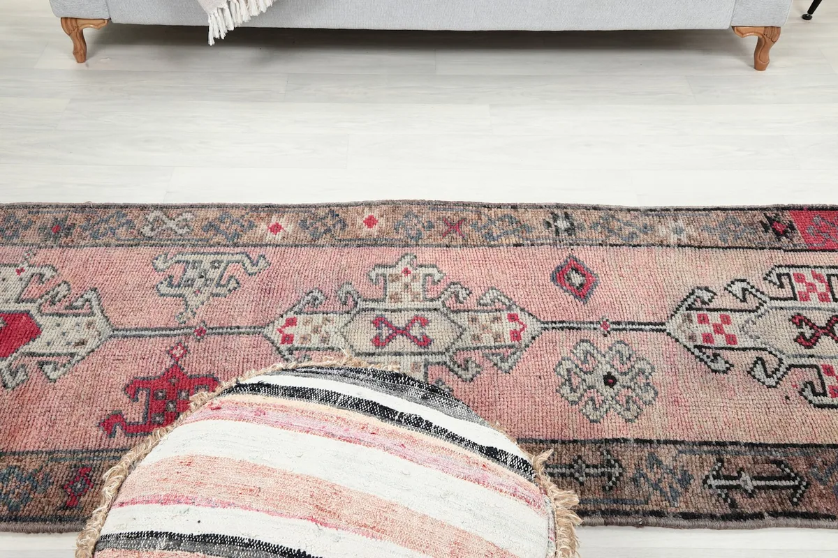 Wider overhead shot of the rug in a room, emphasizing its scale and design within the decor.