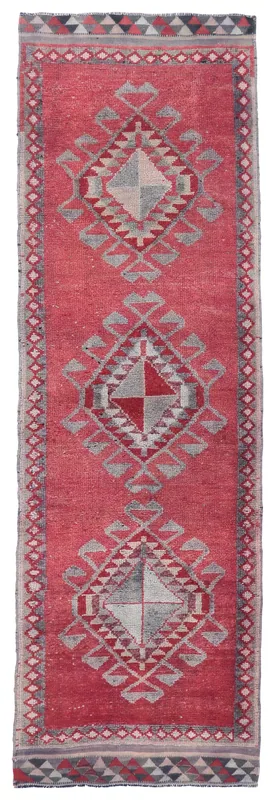 Full top view of the 3'7" x 11'5" rose and gray vintage Anatolian runner rug on a white background.