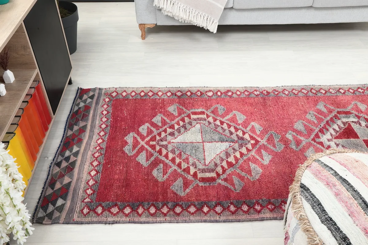 Long view of the runner rug extending into a living area, showing its scale and pattern repeat.