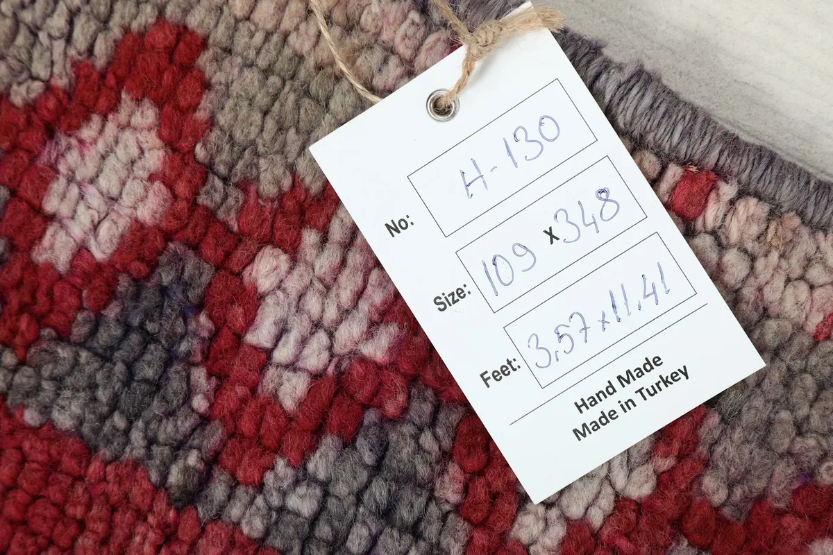 Product tag on the rug displaying size information: 109 x 348 cm, 3.57 x 11.41 feet, hand made in Turkey.