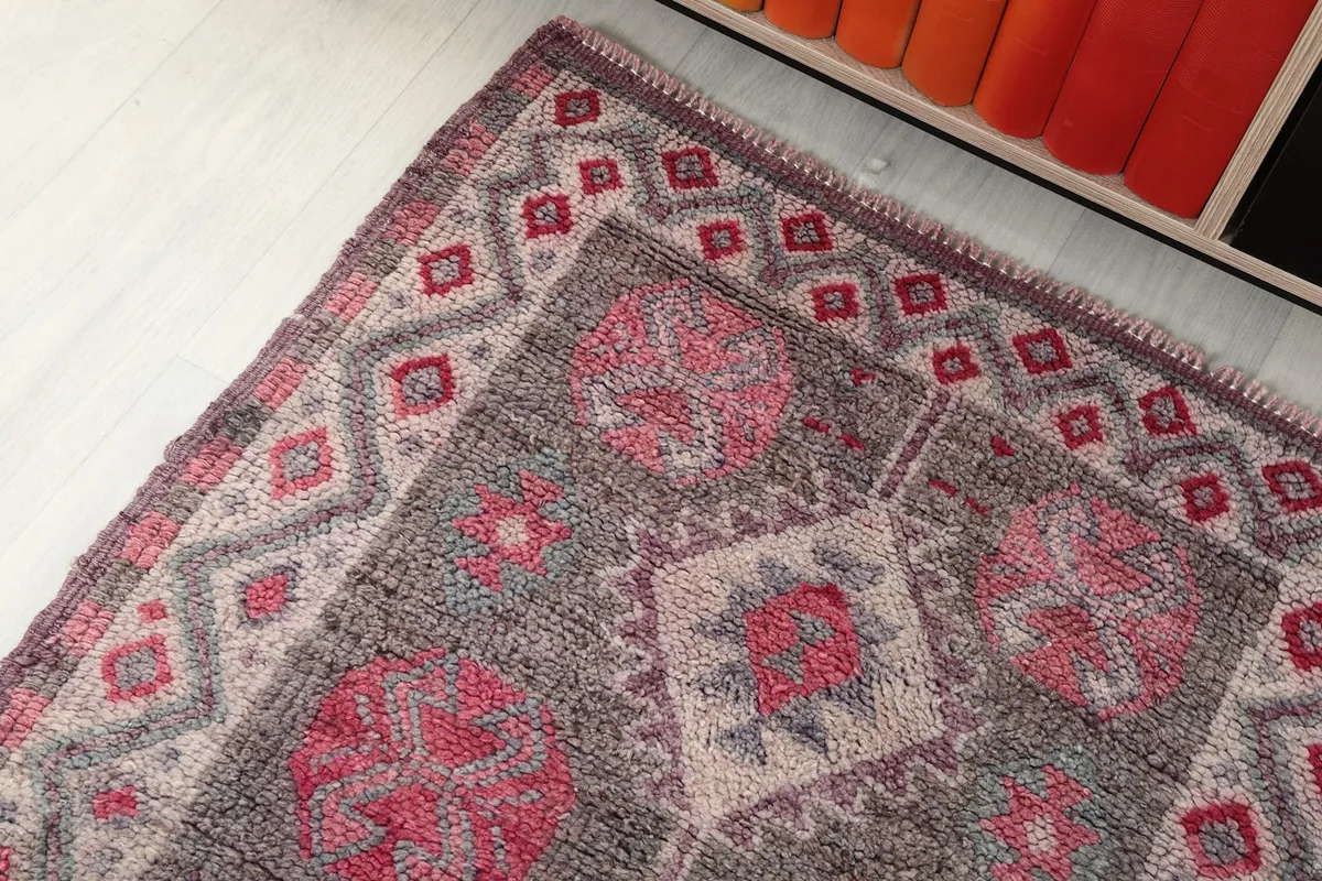 Corner view of the runner rug, showing the intricate border design and field patterns