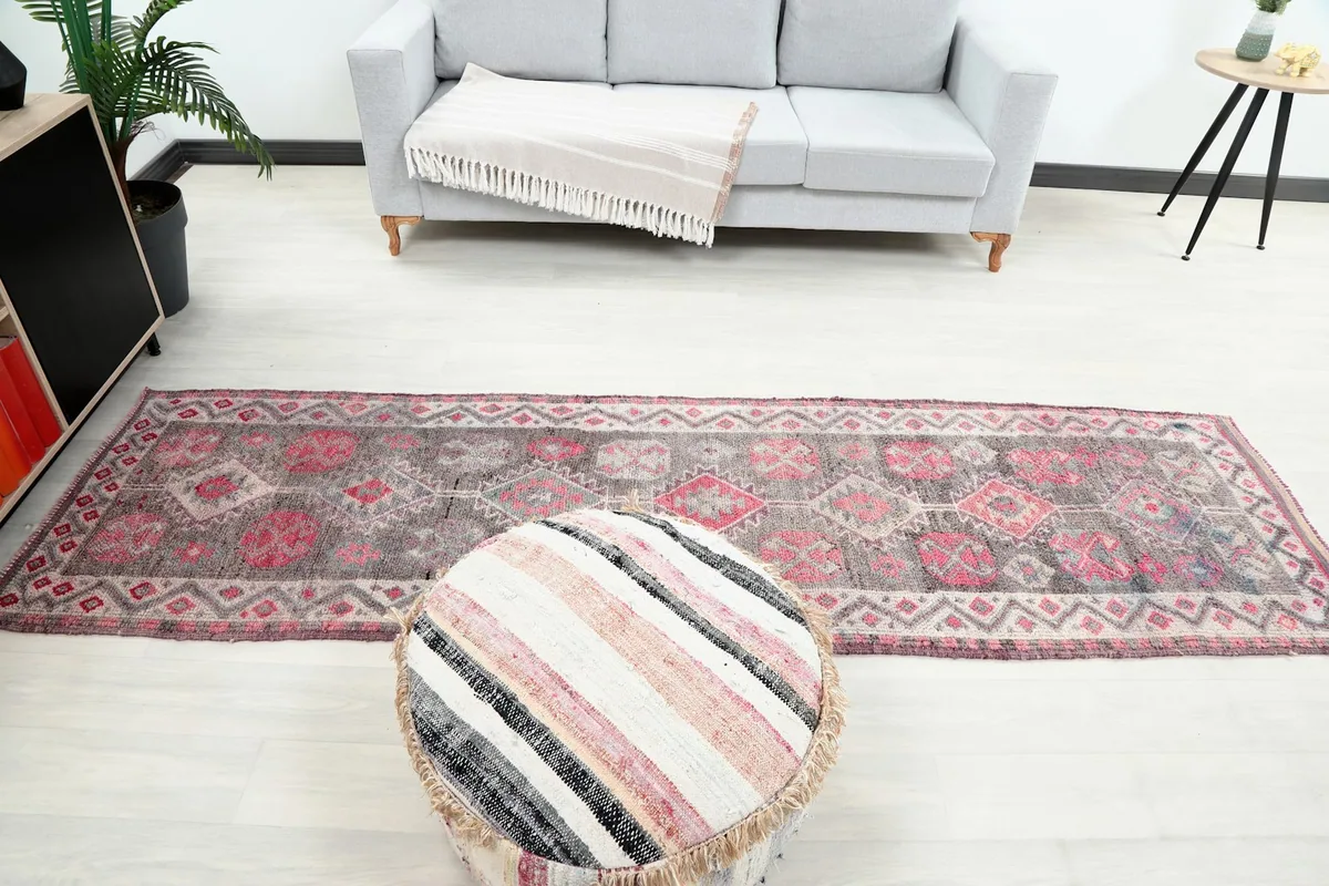 Full length view of the runner rug in a living room, positioned in front of a sofa