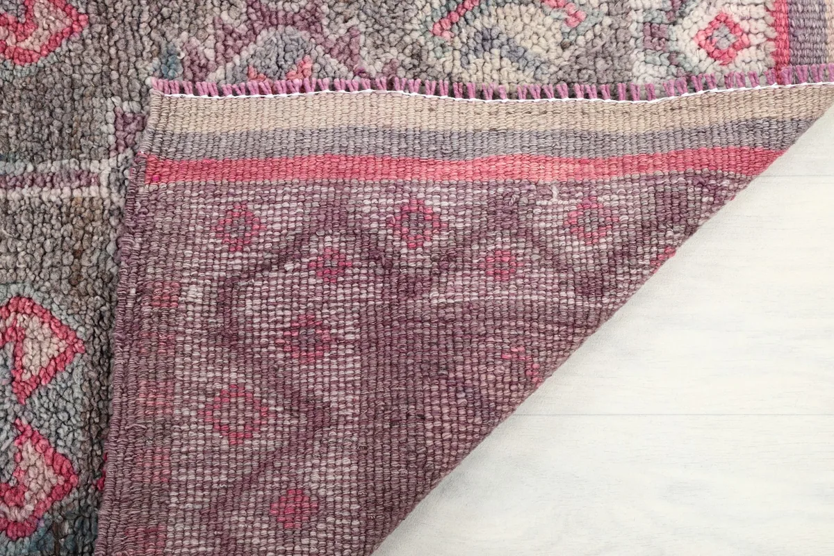View of the back of the hand-knotted rug, revealing the cotton foundation and construction