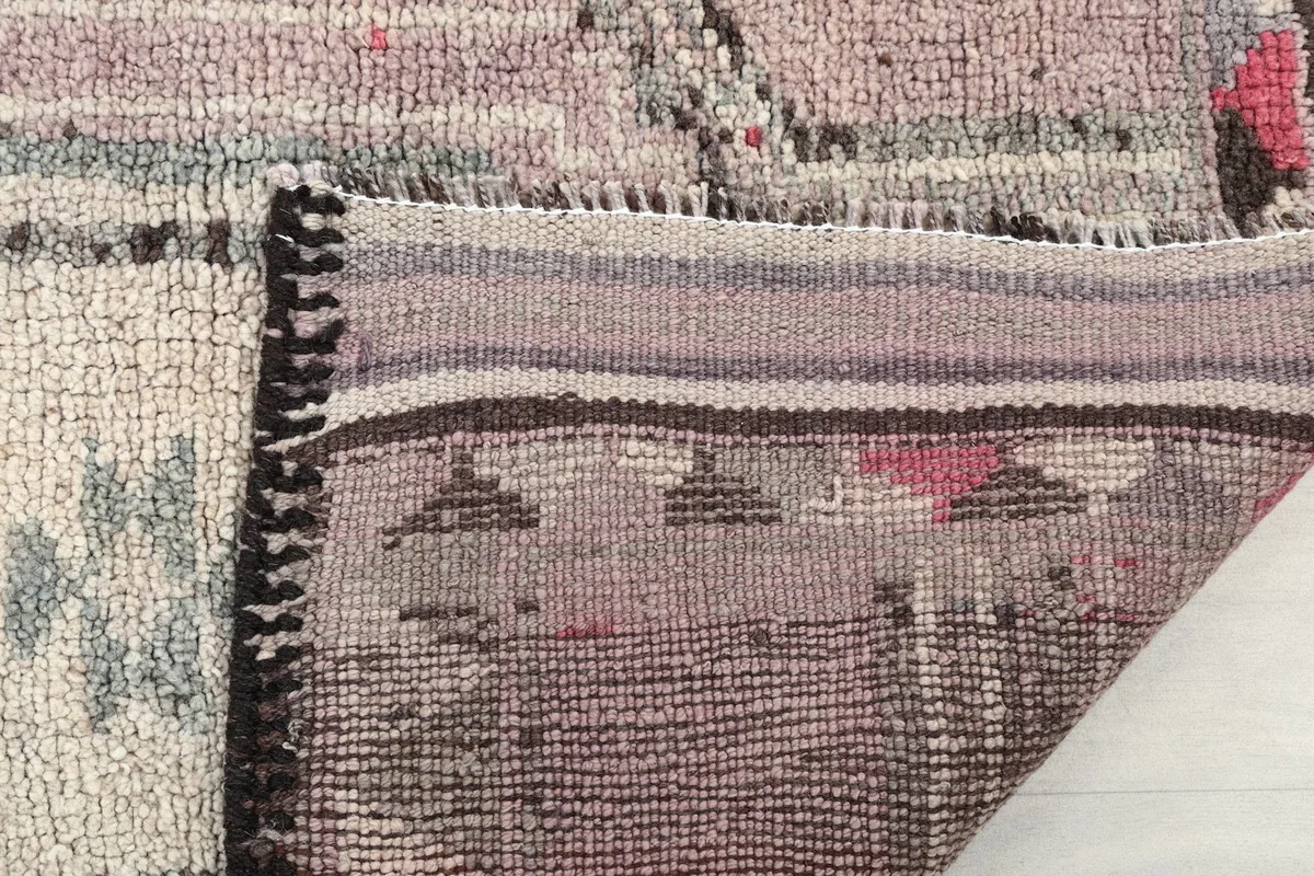 Close-up of the back of the rug, revealing the hand-knotted construction and fringe.