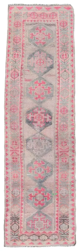 Overhead view of the beige and rose geometric Anatolian runner rug