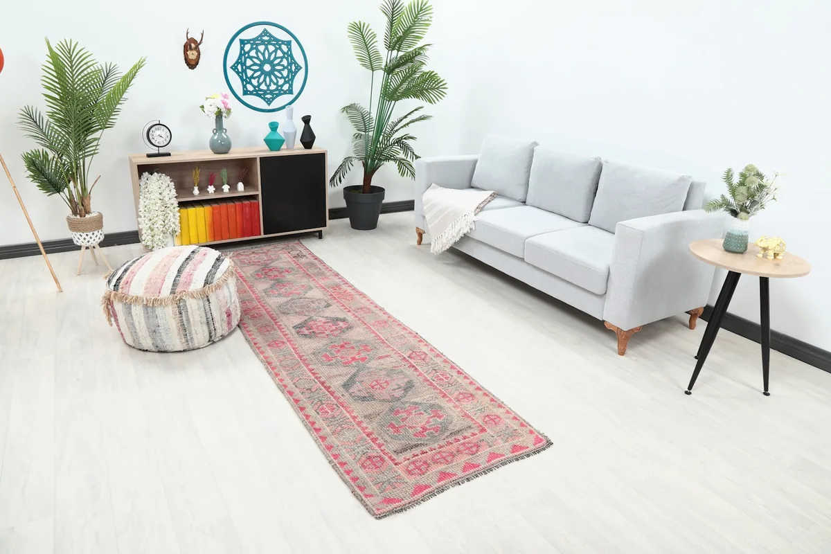 Runner rug in a living room, showing its full length next to a sofa