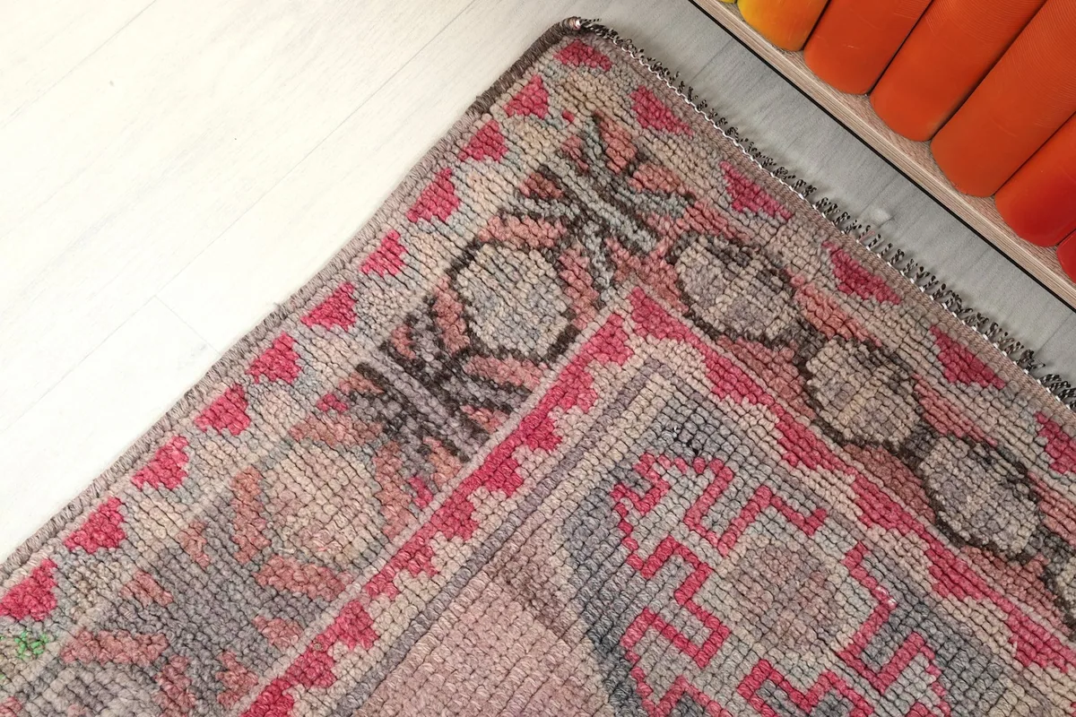 Corner detail of the rug, highlighting the geometric border patterns