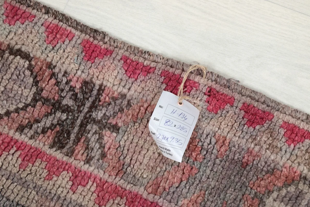 Detail showing the product tag attached to the rug, indicating size and origin
