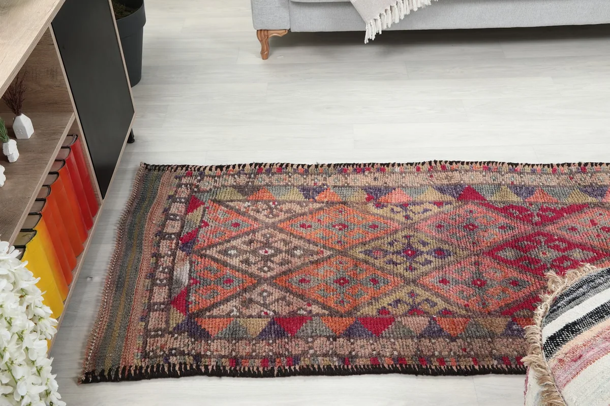 Runner rug extending through a hallway, viewed from a slightly elevated perspective