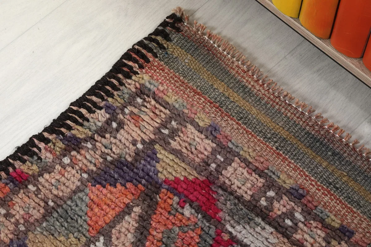 Corner detail showing the finished edge, side binding, and subtle color changes in the border area