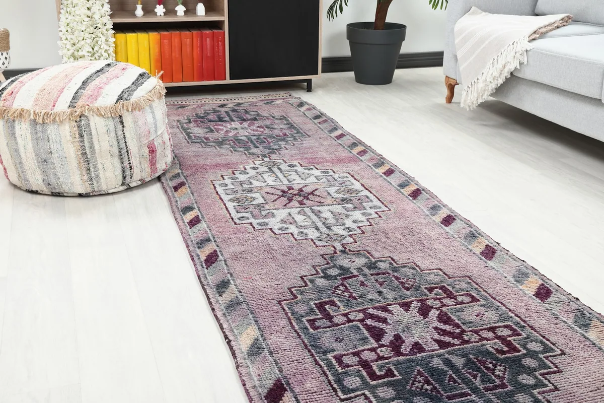 Close-up view of the runner rug in a room, showing the central tribal medallion and colors.