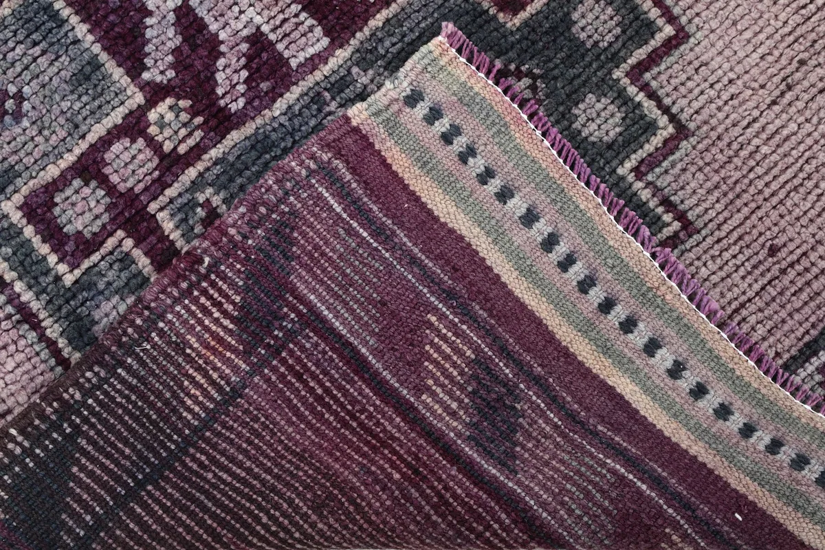 View of the back of the hand-knotted rug, revealing the cotton foundation and knotting.