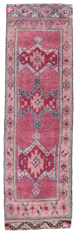 Full top view of the 3'1" x 10'8" rose and navy geometric Anatolian runner rug.