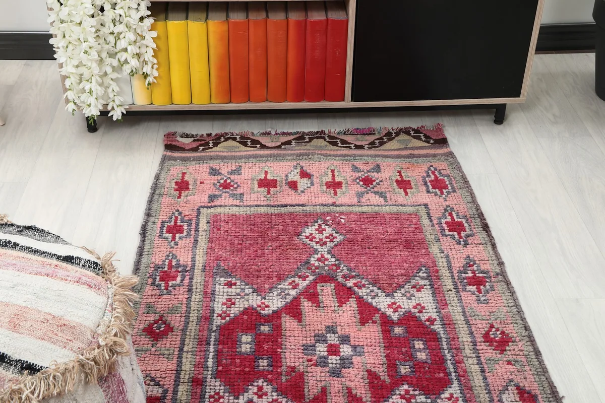 Overhead view of one end of the runner rug placed in a room next to furniture.