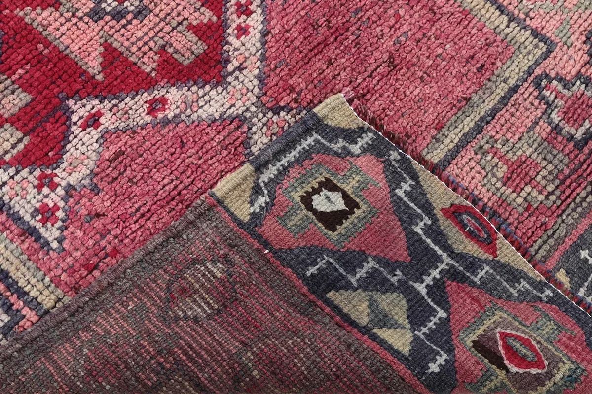 Underside view of the hand-knotted rug, revealing the cotton foundation and knotting.