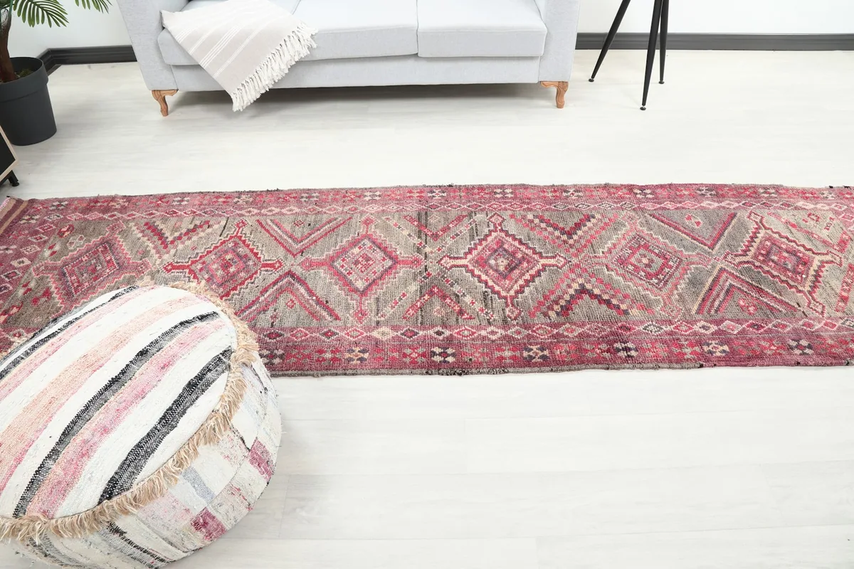 Full length room view of the vintage rose and gray runner rug, showcasing its scale