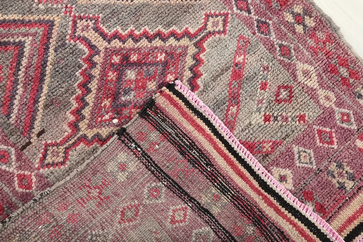 Corner view showing the reverse side of the hand-knotted rug and its woven structure