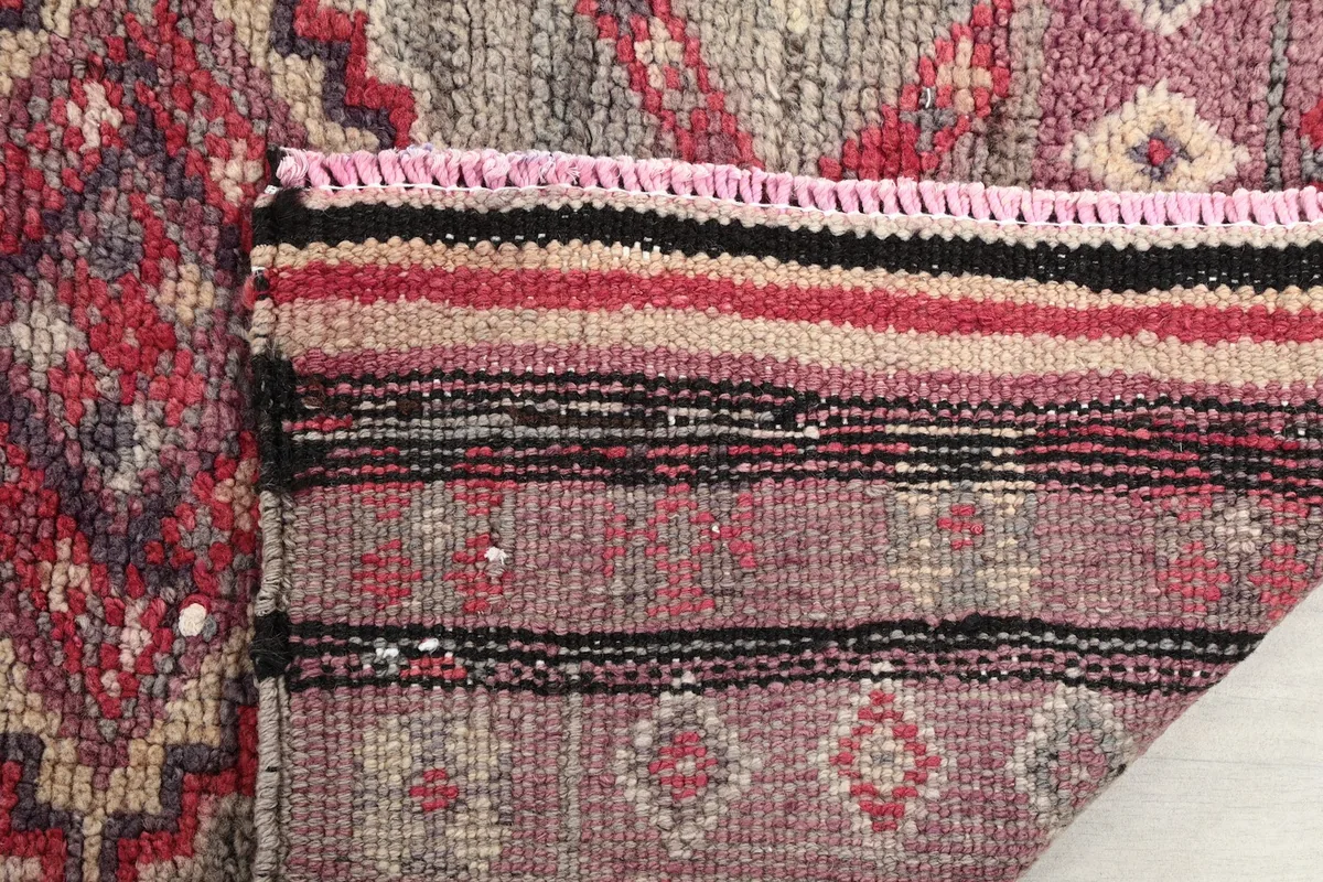 Close-up of the rug's back, revealing the cotton foundation and fine knotting