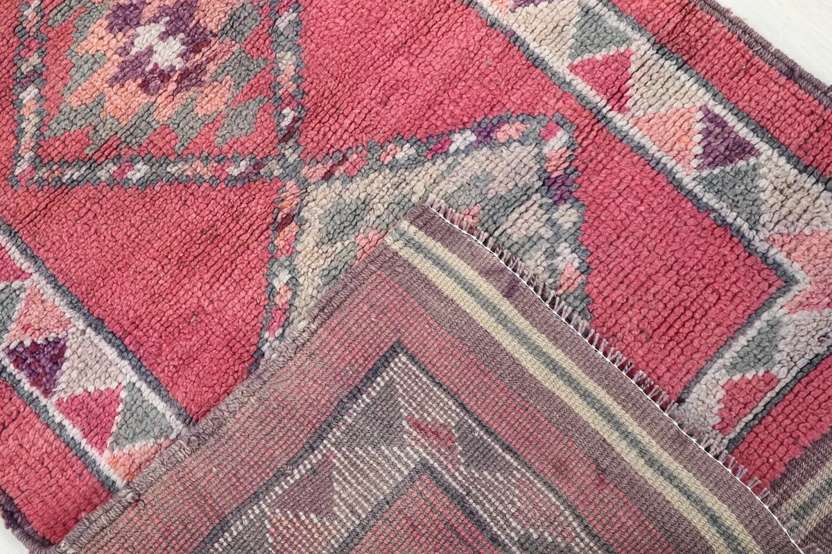 View of the back of the rug, showing the cotton foundation and the tightly hand-knotted wool construction.