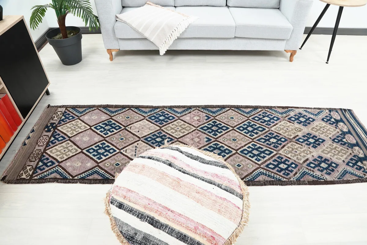 Full length view of the runner rug placed in a living area with a sofa
