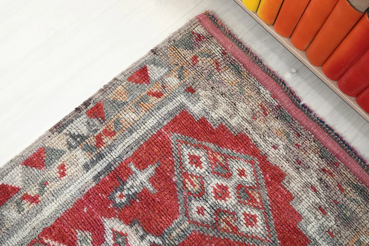 Detail of the rug's border design and corner, showcasing the intricate weaving and colors.