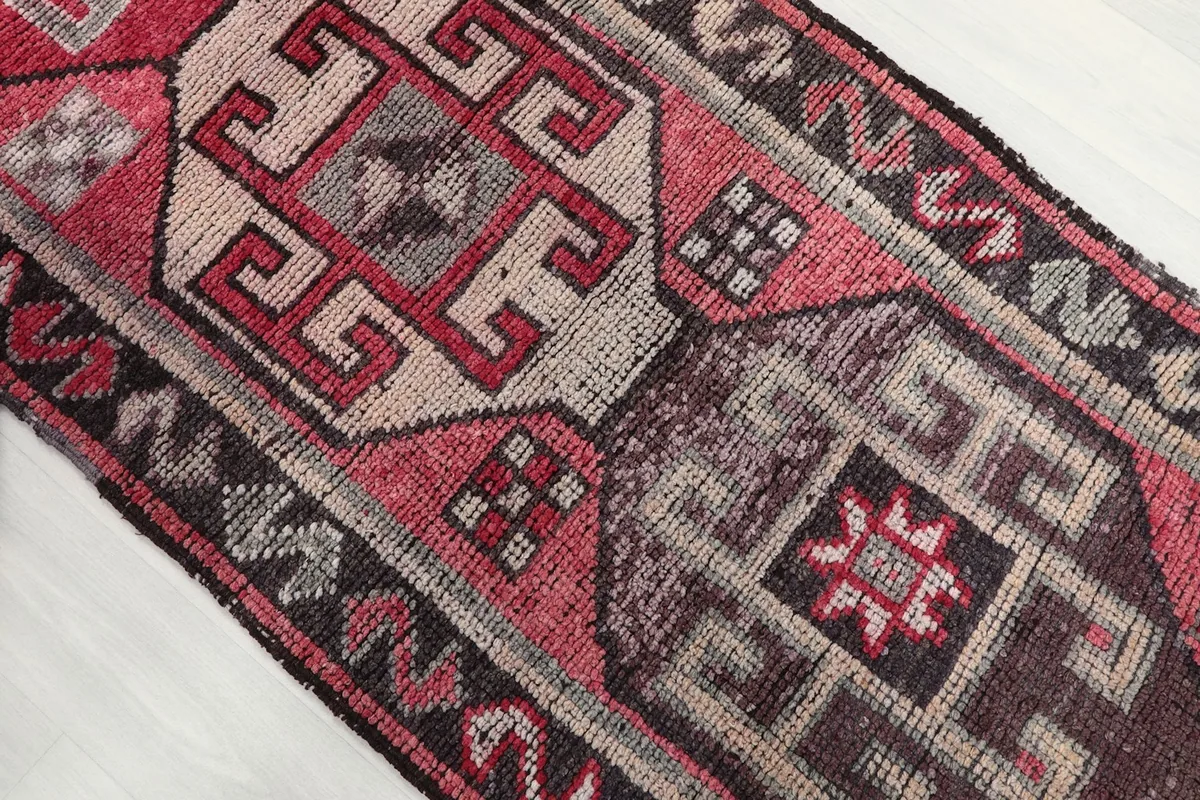Angled view showing the distressed texture and intricate patterns across the rug's surface