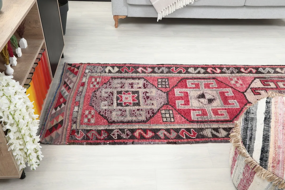 Runner rug extending through a room, showing its length and how it defines the space