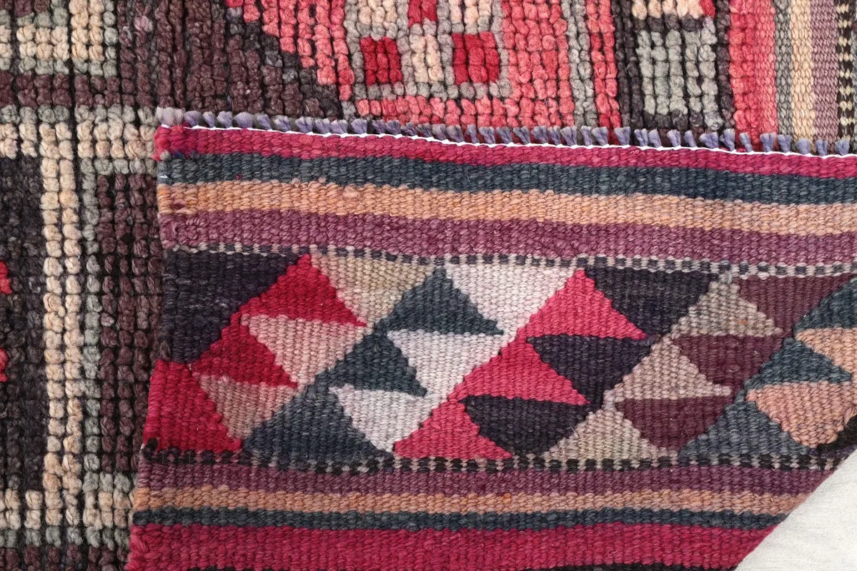 Detail of the rug's fringe and the tightly woven edge, showing craftsmanship