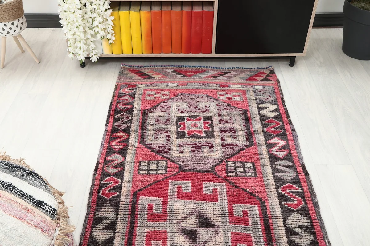 Overhead view focusing on the central portion of the rose and gray runner rug