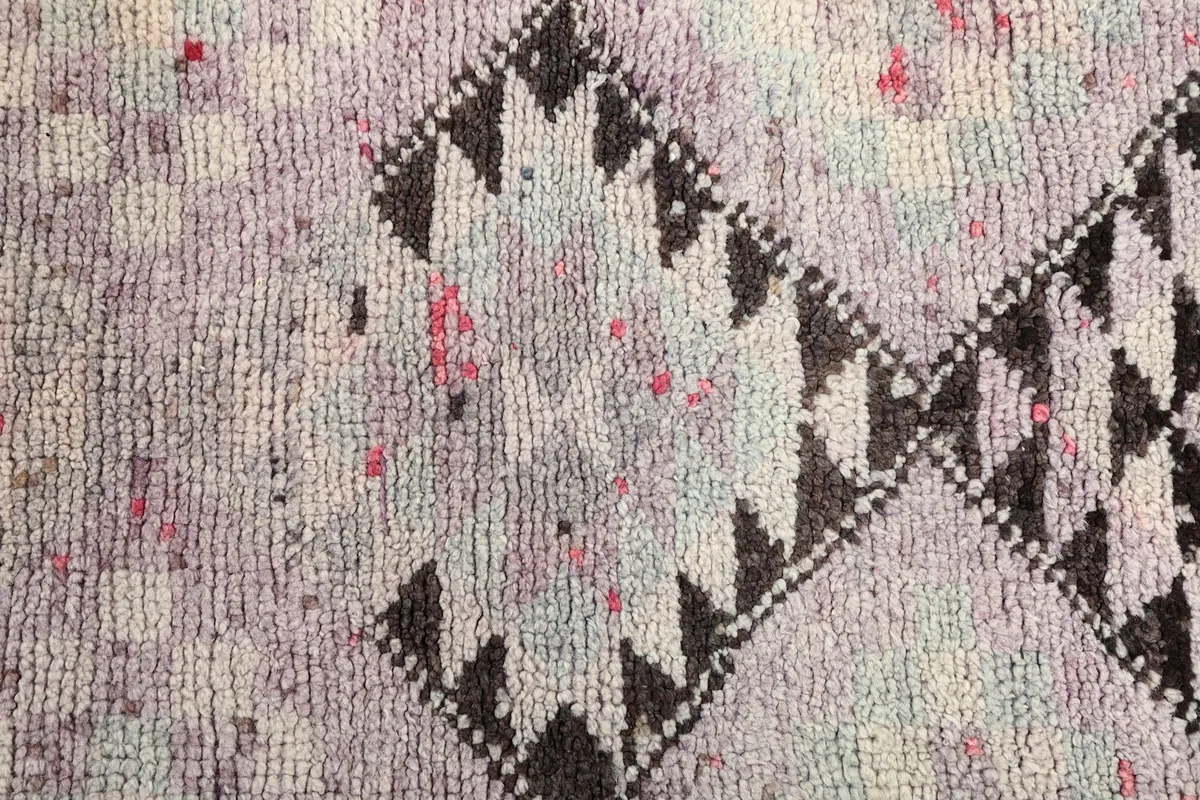Detailed view of the faded black and multicolor geometric design on the runner