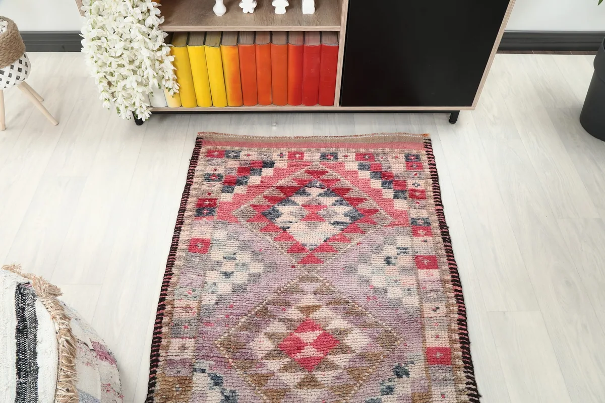 Overhead view of the upper half of the runner rug in a room setting