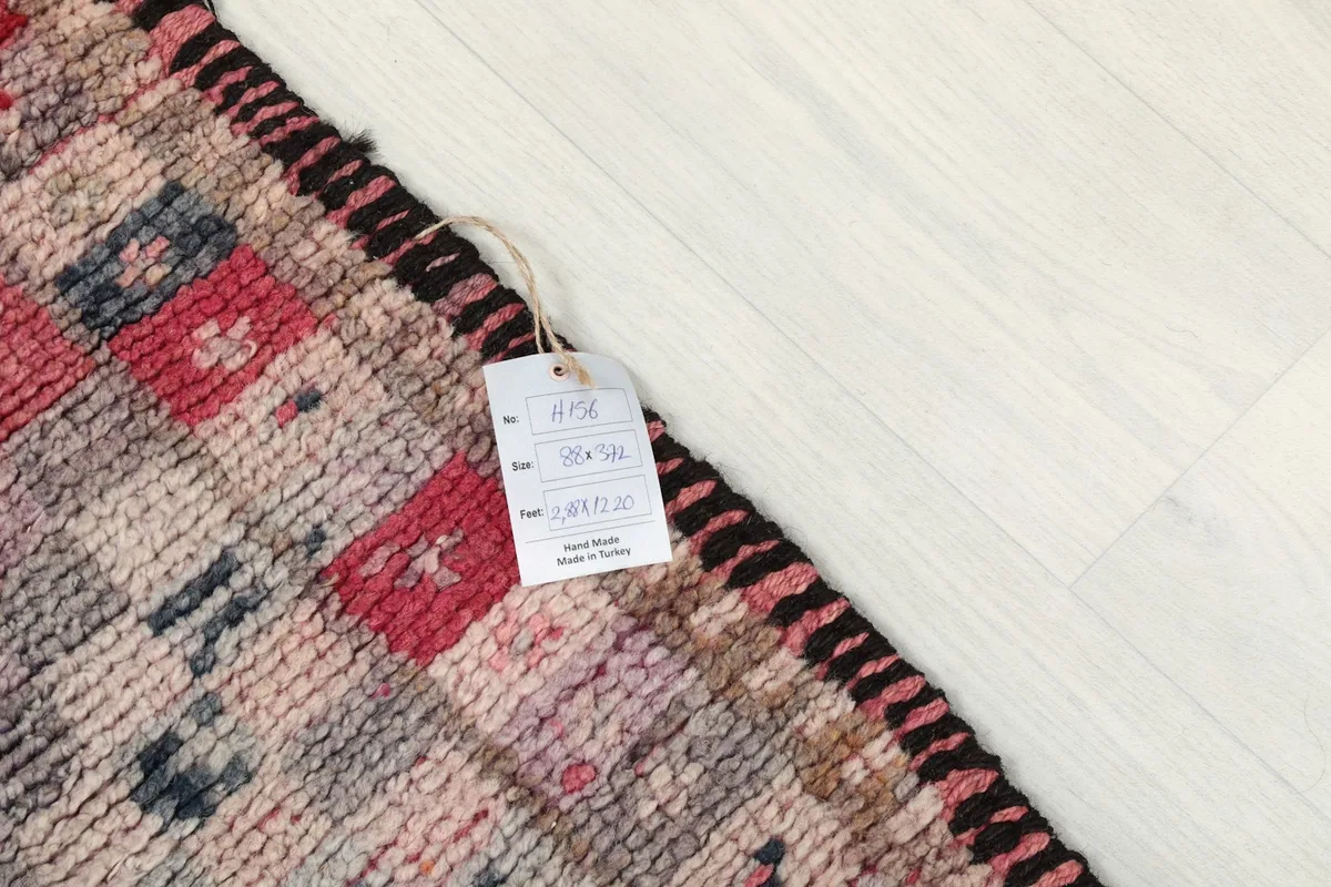 Close-up of a rug tag showing size and origin details on the runner