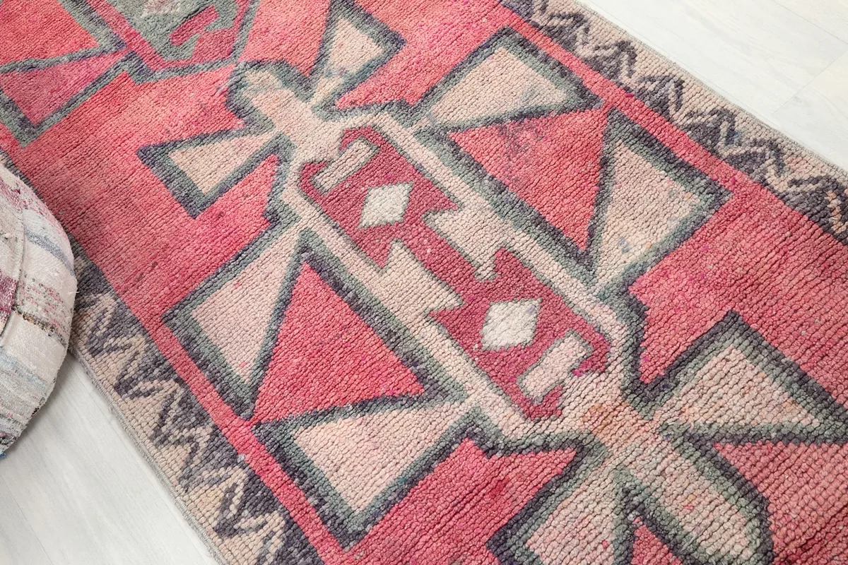 Angled view highlighting the central beige and rose geometric medallion-like motifs